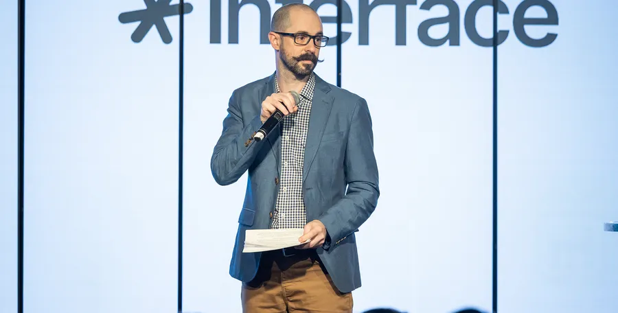 Speaking on stage at Interface conference